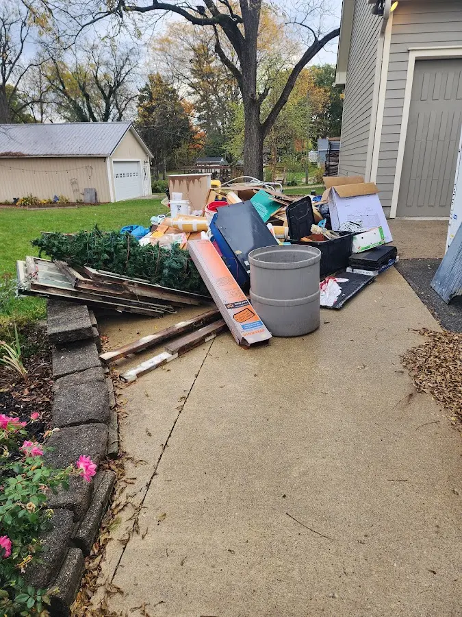 Dumpster being loaded with debris for 12 Yard Dumpster Rental in Ferndale